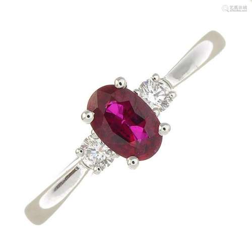 An 18ct gold diamond and ruby three-stone ring.Total