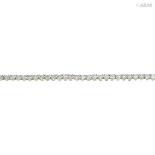 A 14ct gold diamond line bracelet.Estimated total