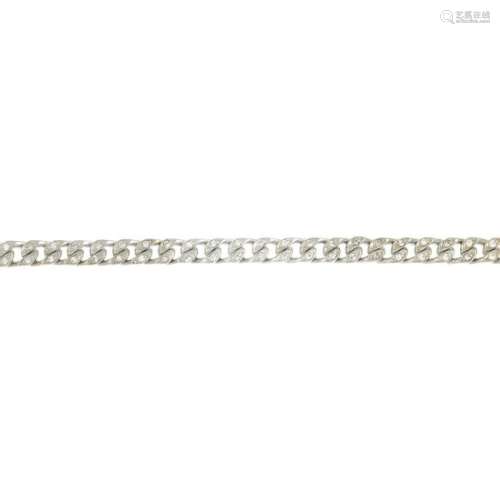 A diamond curb-link bracelet.Estimated total diamond