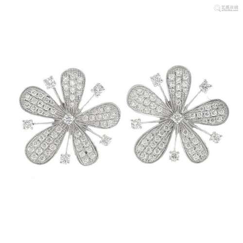 A pair of 18ct gold diamond flower earrings.Total