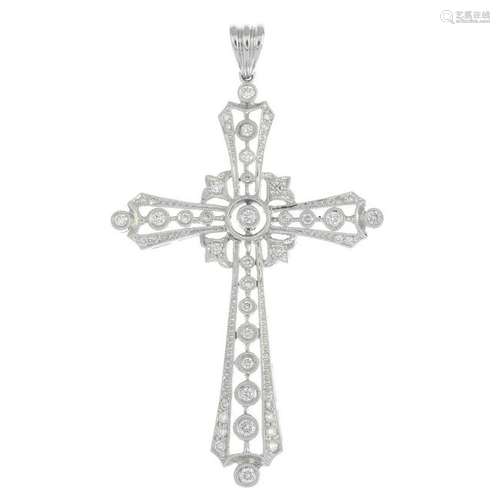 A diamond cross pendant.Total diamond weight