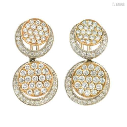 A pair of diamond disc earrings.Estimated total diamond
