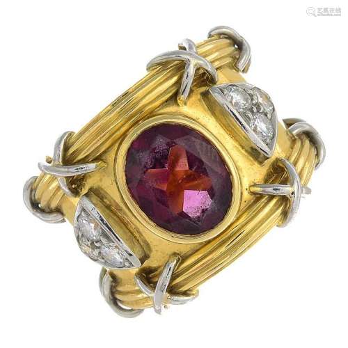 An 18ct gold garnet and diamond dress ring.Estimated