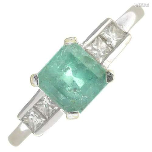An 18ct gold emerald and diamond dress ring.Estimated