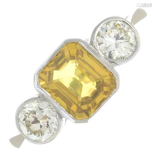 A yellow sapphire and diamond three-stone ring.Sapphire