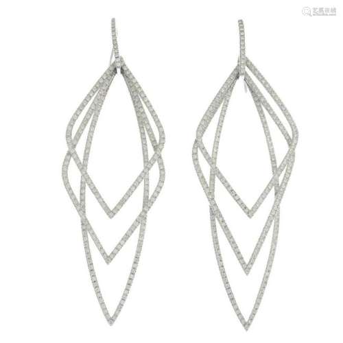 A pair of diamond earrings.Estimated total diamond