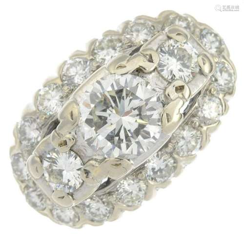 A brilliant-cut diamond three-stone cluster ring.