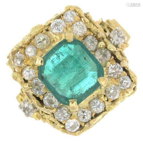 An emerald and diamond dress ring.Emerald calculated