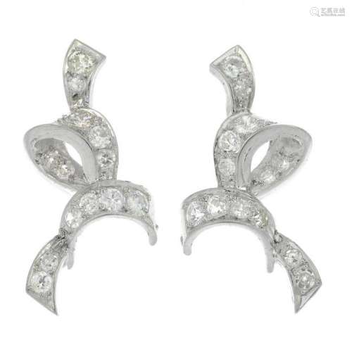 A pair of diamond scroll earrings.Estimated total