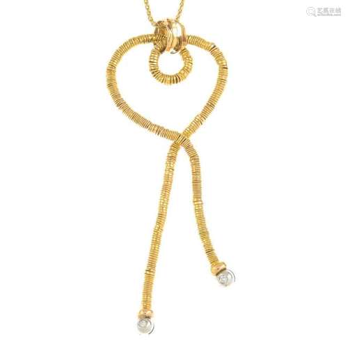 An openwork heart pendant, with diamond highlights,