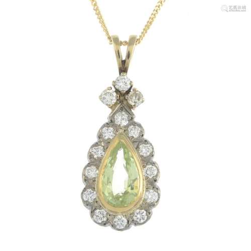 A peridot and diamond cluster pendant, suspended from