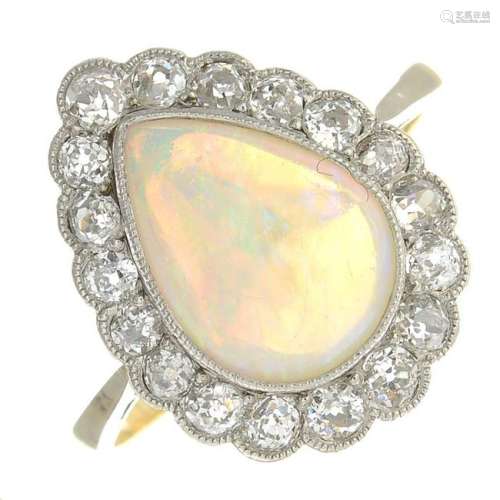 An opal cabochon and diamond cluster ring.Estimated