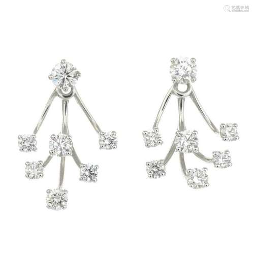 A pair of diamond earrings.Total diamond weight