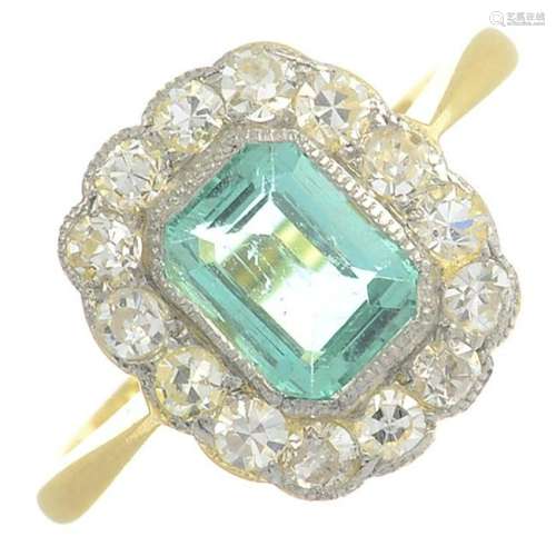 An emerald and diamond cluster ring.Emerald weight
