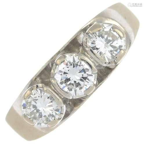 A brilliant-cut diamond three-stone ring.Total diamond