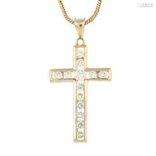 A diamond cross pendant, suspended from a snake-link