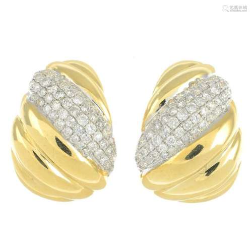 A pair of diamond earrings.Total diamond weight