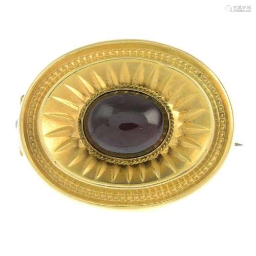 A late Victorian gold garnet brooch, with glazed panel