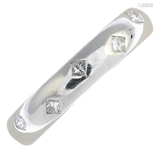 A platinum diamond band ring.Estimated total diamond