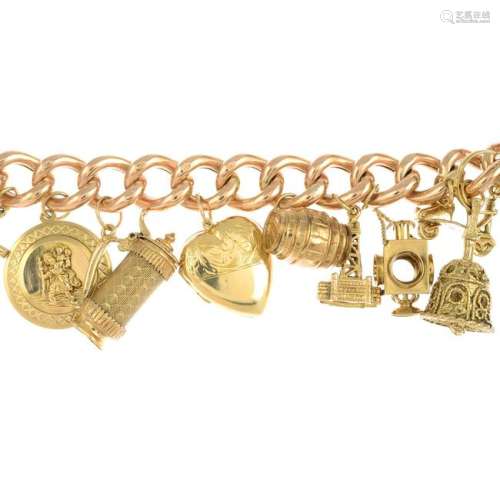 An Edwardian 9ct gold charm bracelet, suspending