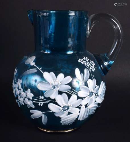 AN ANTIQUE BLUE GLASS JUG painted with flowers,