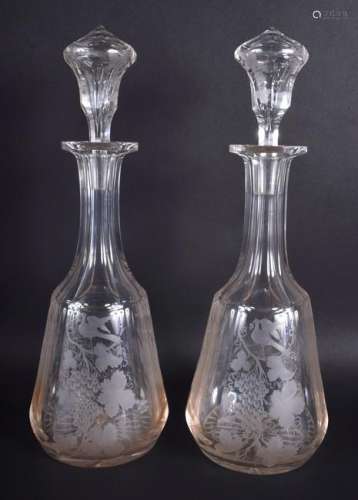 A LARGE PAIR OF ANTIQUE GLASS DECANTERS AND STOPPERS