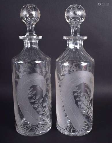 A PAIR OF ANTIQUE GLASS DECANTERS AND STOPPERS engraved