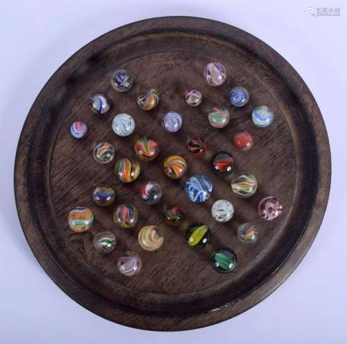 VICTORIAN SOLITAIRE MARBLES upon a stand. Largest 2.5