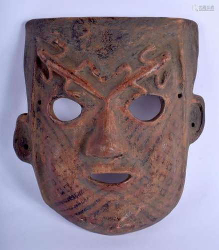 A VINTAGE SOUTH AMERICAN POTTERY MASK overlaid with