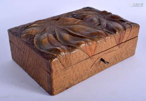 AN ART NOUVEAU CARVED WOOD CASKET decorated with