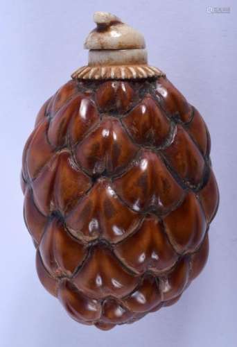 AN EARLY 20TH CENTURY CARVED NUT AND BONE SNUFF BOTTLE.