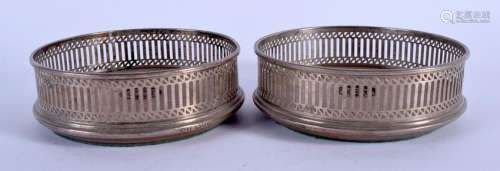 A PAIR OF ENGLISH SILVER BOTTLE COASTERS. London 1986.