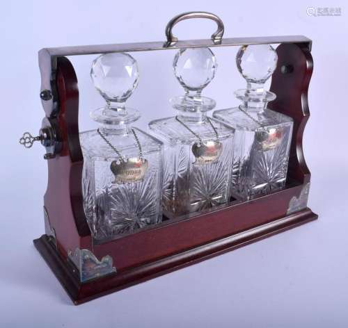 A LARGE MAHOGANY SILVER PLATED TANTALUS together with