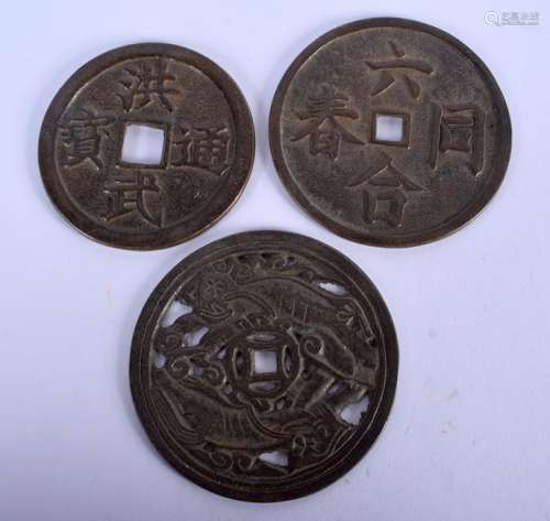 THREE CHINESE BRONZE COINS. 7.75 cm wide. (3)