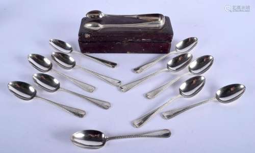 ELEVEN MID VICTORIAN SILVER SPOONS with sugar tongs.