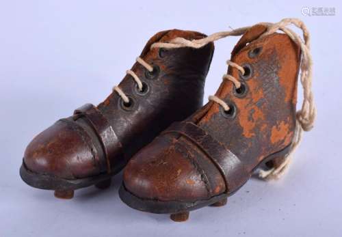 A PAIR OF EDWARDIAN LEATHER FOOTBALL BOOTS. 11 cm wide.