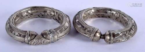 TWO ANTIQUE INDIAN SILVER BANGLES. 9.5 cm wide.