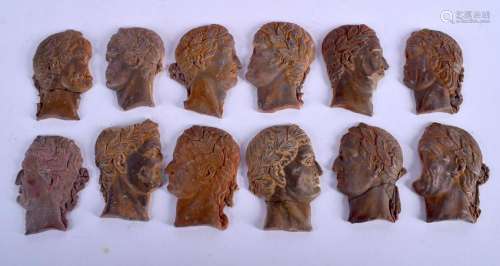A SET OF 19TH CENTURY CARVED ITALIAN TERRACOTTA MASK