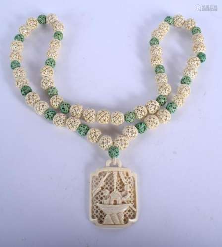 A 19TH CENTURY CHINESE CARVED AND STAINED I NECKLACE