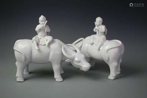 A Pair Of White Glazed Porcelain Figures Of Cowboys