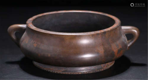 A CHINESE ARCHAIC BRONZE HANDLED ROUND CENSER