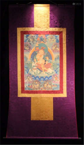 TIBETAN THANGKA OF CORAL SEATED BUDDHA