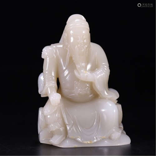 A CHINESE ANCIENT CARVED JADE SEATED WARRIOR