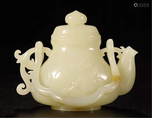 A CHINESE CARVED JADE LONG HANGLE POT