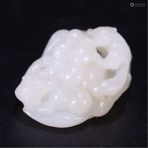 A CHINESE CARVED JADE SQUIRREL AND GRAPES TABLE ITEM