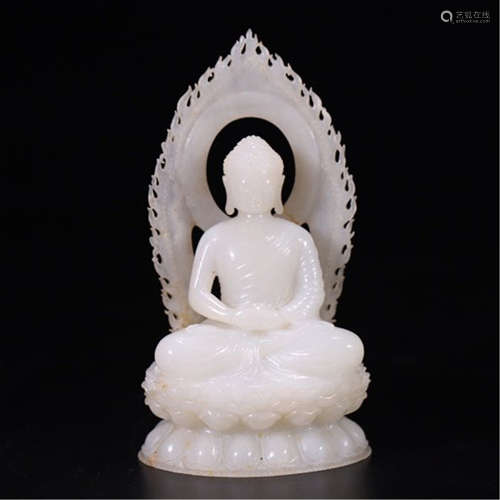 A CHINESE CARVED JADE SEATED GUANYIN