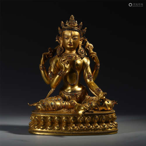 A CHINESE GILT BRONZE FOUR ARMS SEATED GUANYIN