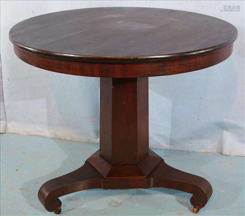 Mahogany round parlor table with scroll feet