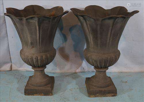 Pair of iron garden urns with scalloped rim