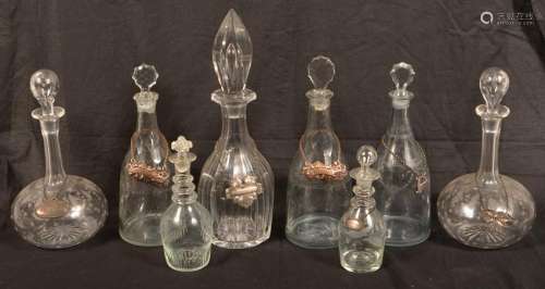Eight Various Colorless Glass Decanters.